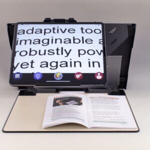 A tablet with a magnified screen projecting text above an open book.
