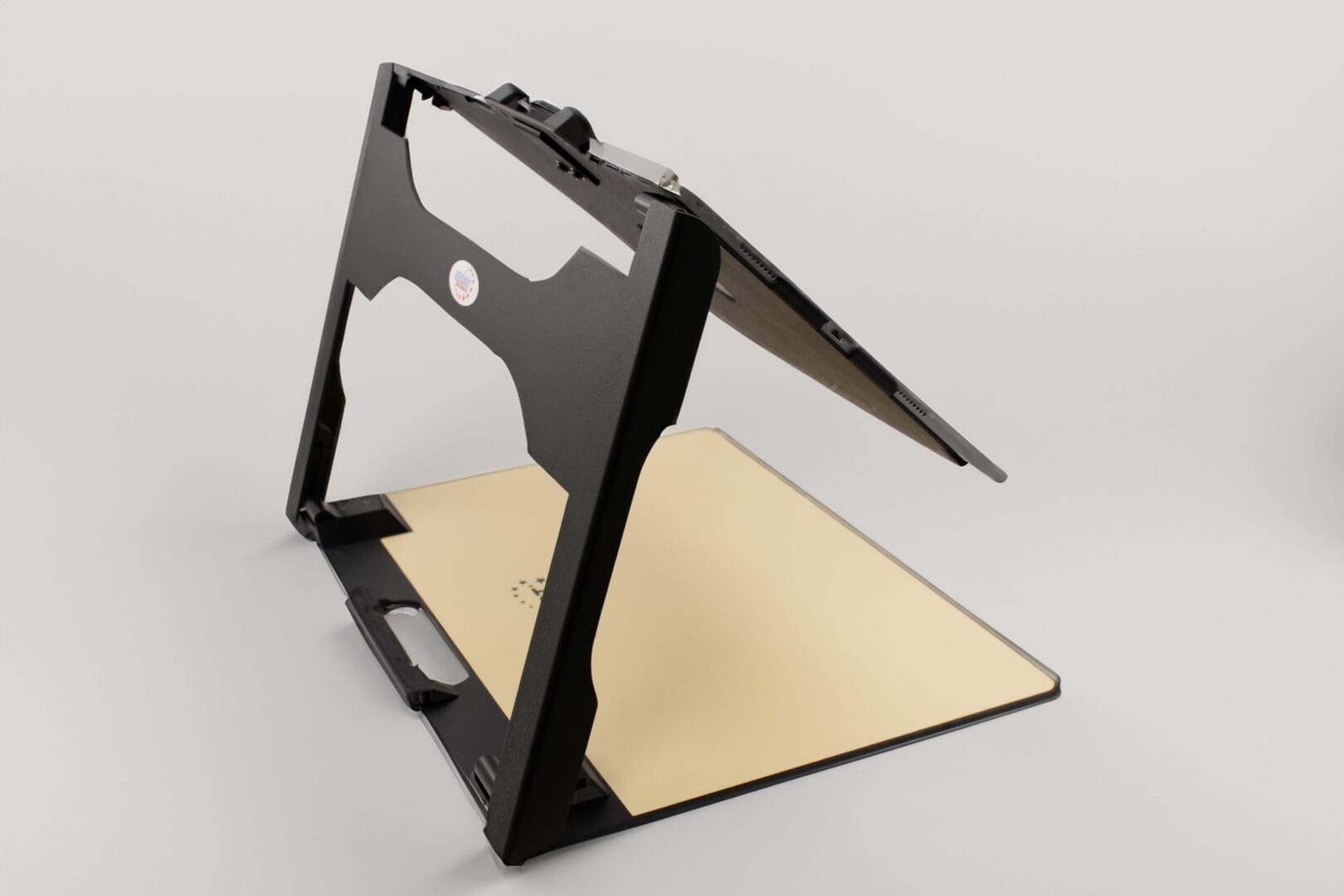 Adjustable black and beige laptop stand with folding design.